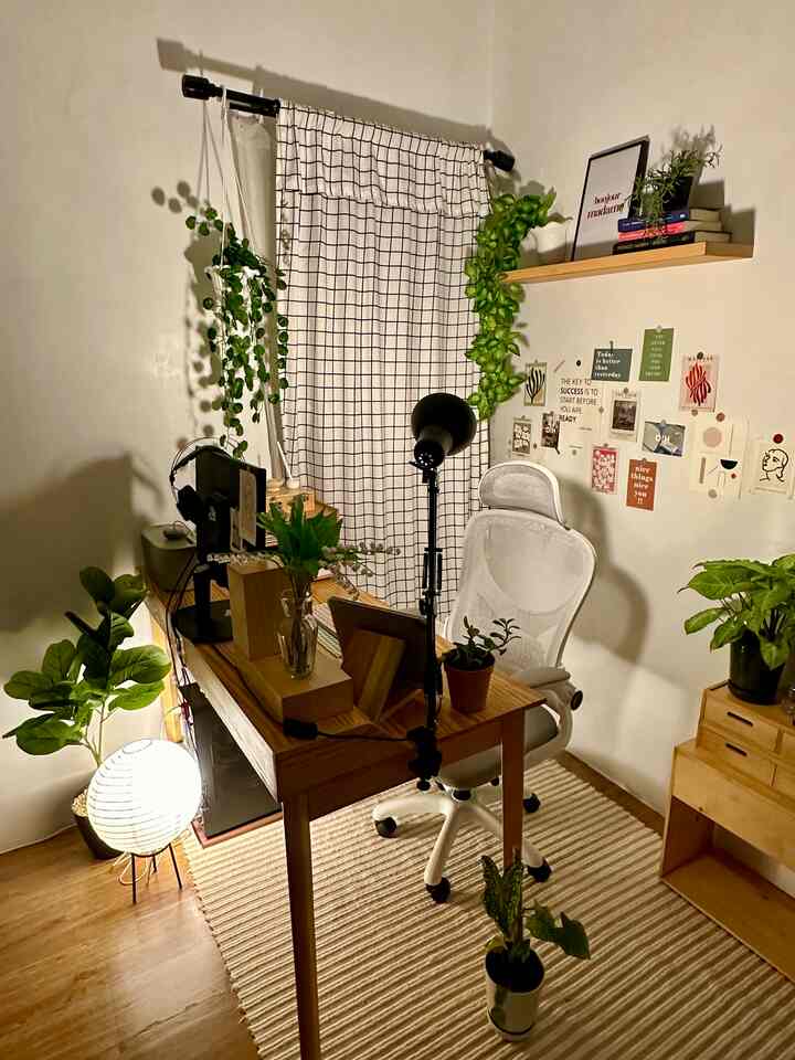 Natural color and wood tone home office featuring a white office chair and wooden desk with warm ambiance