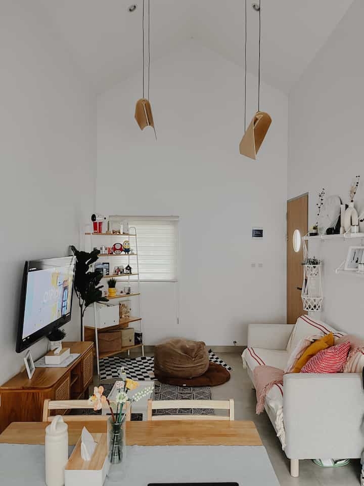 The following are before-after photos of the condition of the living room which is the main heart of the house. One of the reasons we chose this house in the first place was because it had high ceilings and followed the shape of the roof so it could become a distinctive feature of the house and had good air circulation with 2 windows on both sides.
It can be seen that after being filled with furniture, the room doesn't feel cramped, we can also add hanging lamp accents because of the ceiling concept.

#LivingRoomStyling #LivingRoomIdeas #LivingRoomInspo #scandinavian #rumahcluster #DiningRoomDesign #LivingRoomDecor