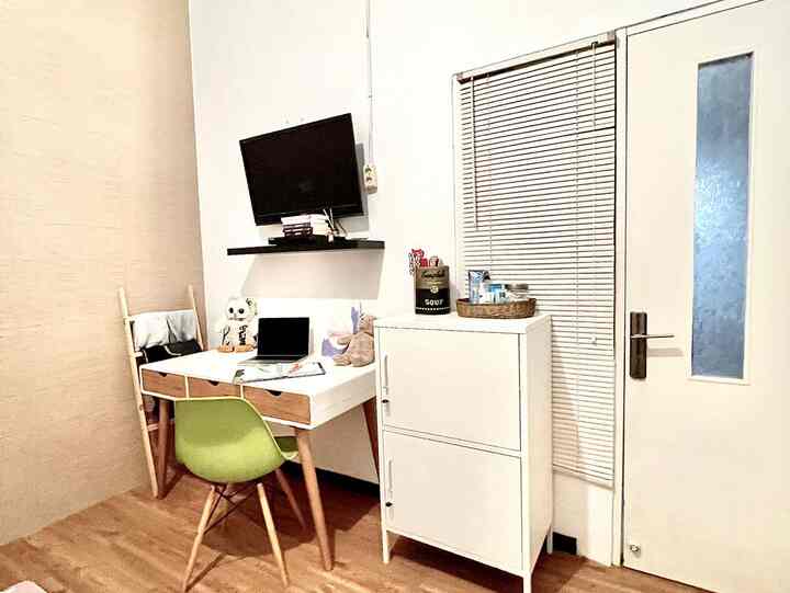 White and brown toned compact small room with desk and chair arranged as remote work space