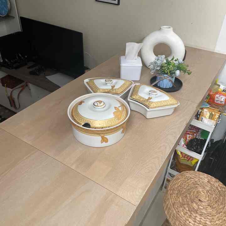 Natural beige tone kitchen dining table featuring ceramic tableware and kitchen items in a cozy space