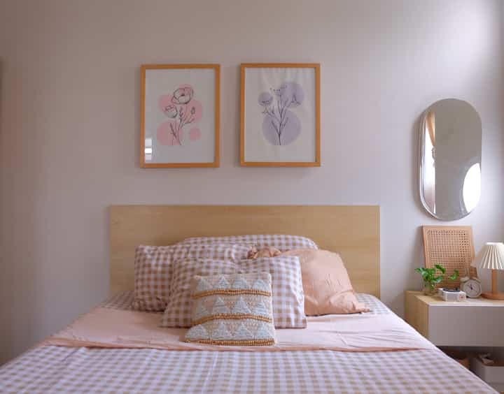 Natural toned bedroom featuring a wooden bed frame and neat bedding creating a cozy atmosphere
