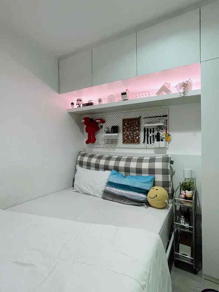 White and silver toned bedroom featuring a checkered headboard and side trolley in a clean minimal interior