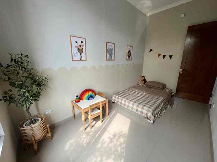 Beige toned kids' room featuring children's bed and desk with a natural, cozy atmosphere