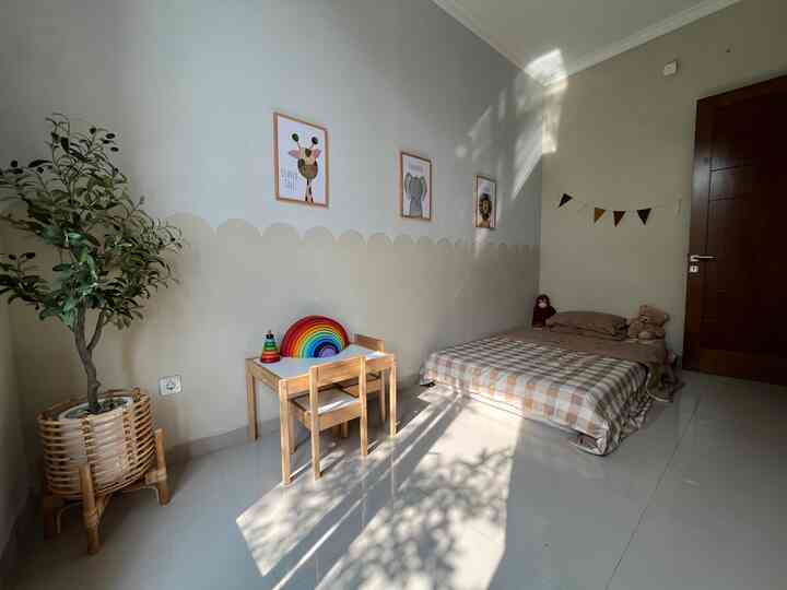Bright white and beige toned room featuring kids' furniture and a floor mattress with a warm natural feel