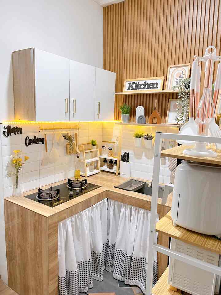 White and brown toned kitchen featuring wood wall panels and neat storage, creating a cozy atmosphere