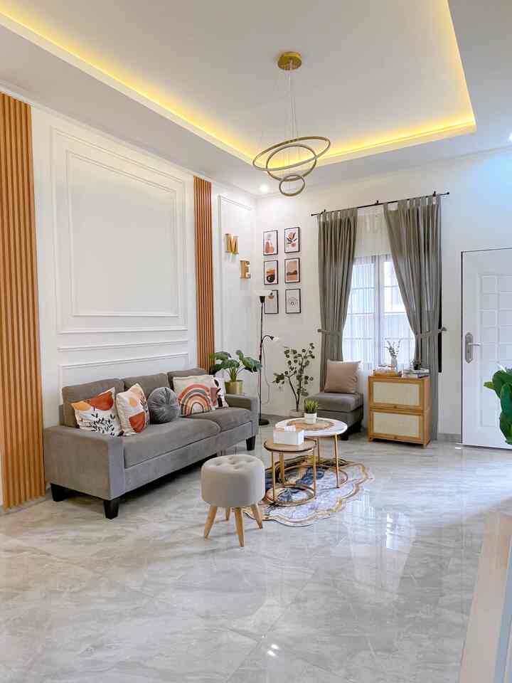 Natural and gray toned living room featuring a gray sofa, beige side tables, and pendant lighting creating a clean atmosphere