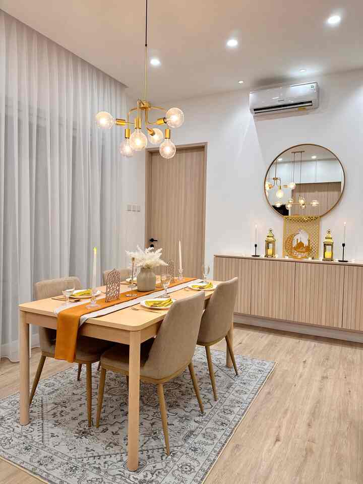 Natural modern toned dining room featuring light wood dining table and beige chairs on a patterned carpet in a clean setting