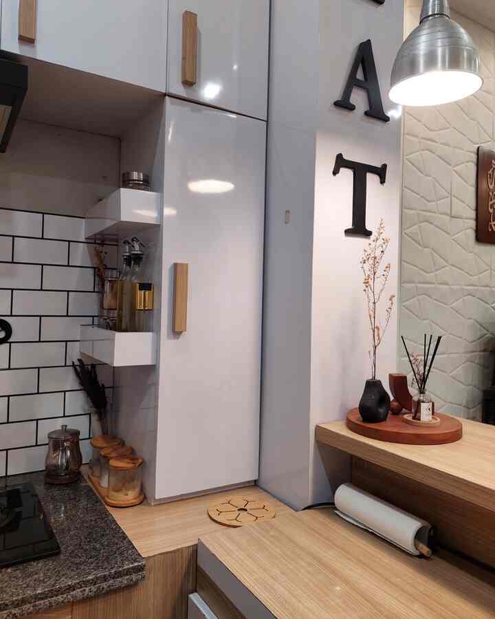 White and natural tone kitchen space featuring clean storage and modern design elements