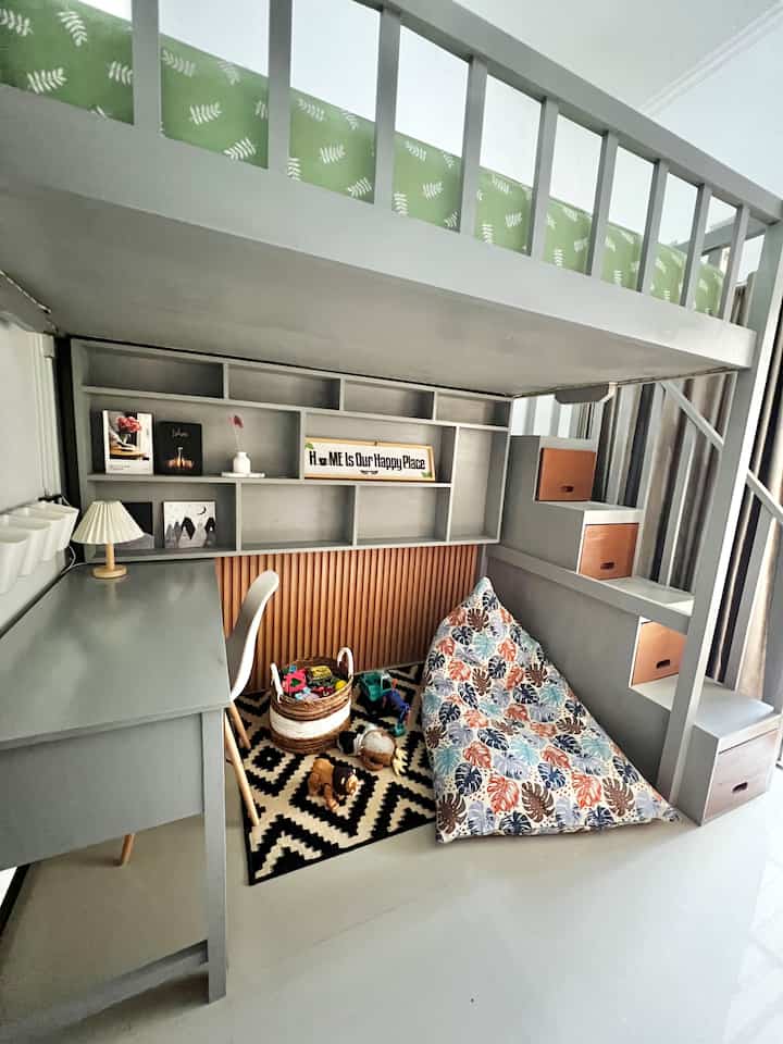 Gray and white toned kids' room featuring a loft bed over a children's play area with multifunctional furniture, creating a cozy space