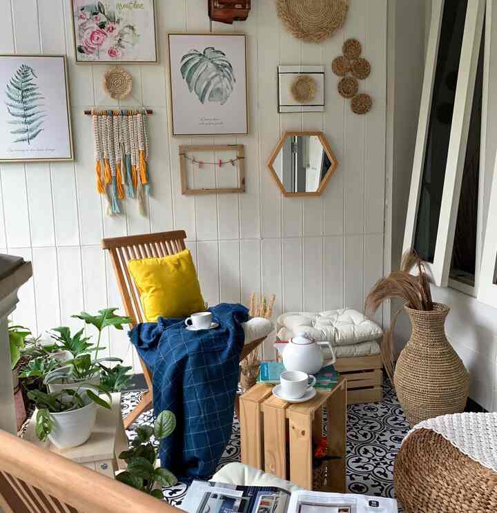 A beige and natural tone living room featuring wood furniture, wall art, plants, and a cozy home cafe atmosphere