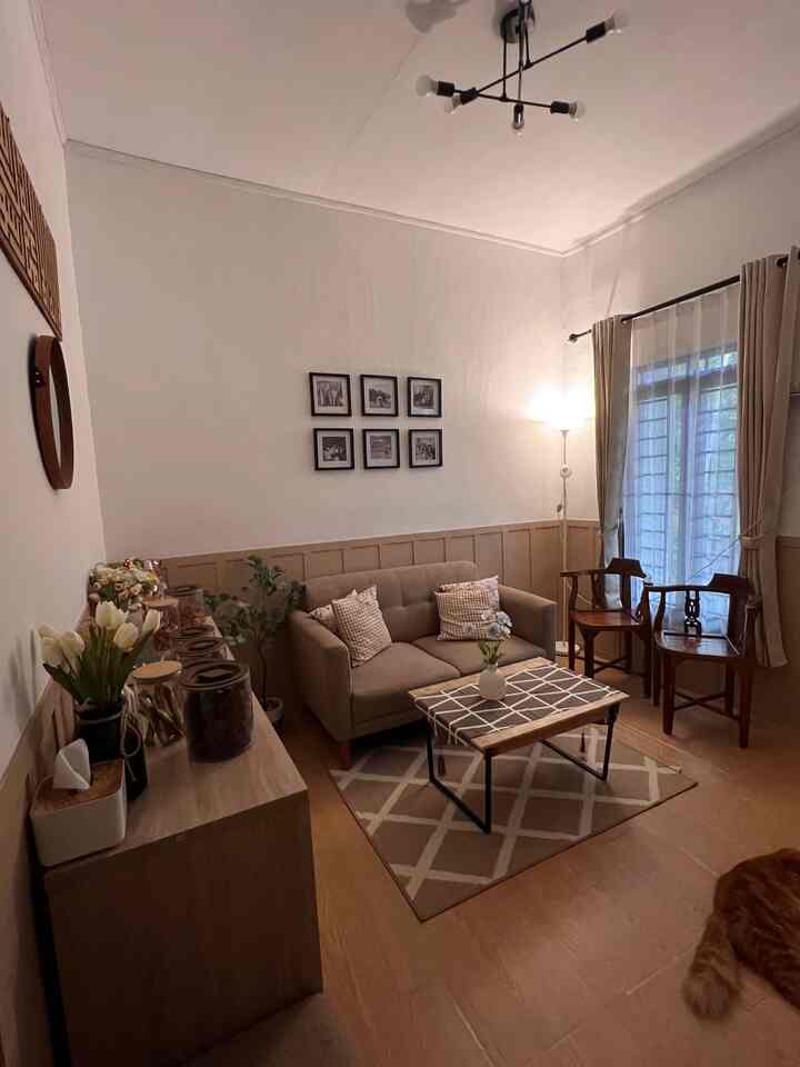 Beige and brown toned living room featuring sofa, coffee table, and wall decor with warm atmosphere