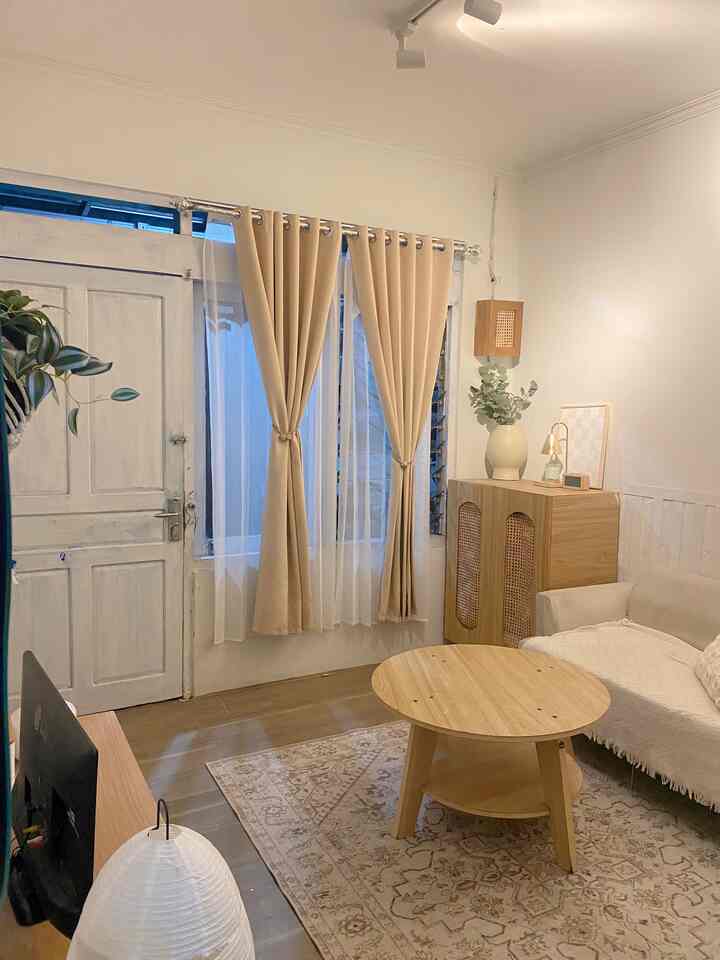 Simple Japandi style living room with white walls and light brown wood-tone furniture