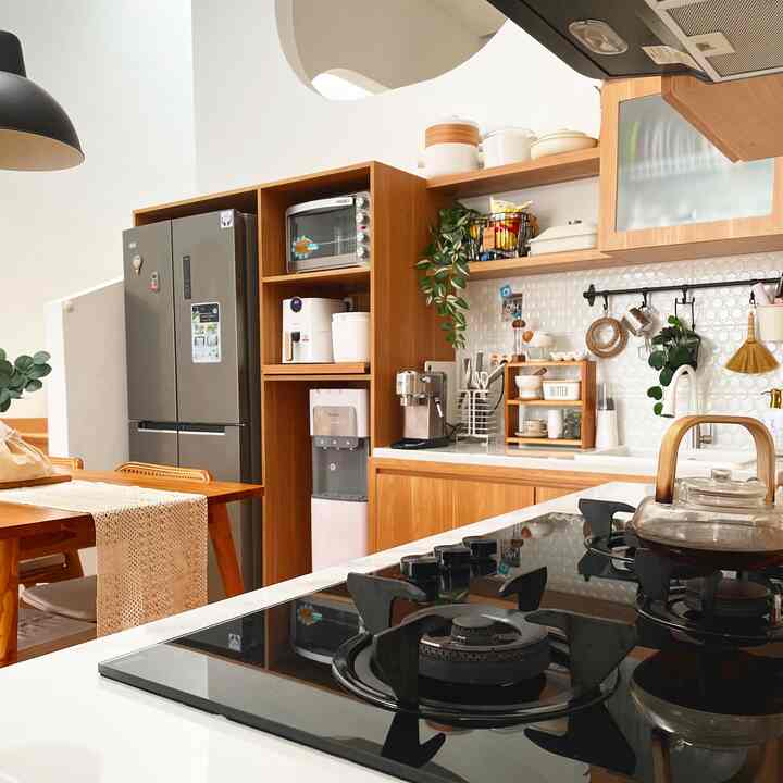 White and wood tone kitchen featuring a gas cooktop and wooden cabinetry, creating a clean and warm atmosphere