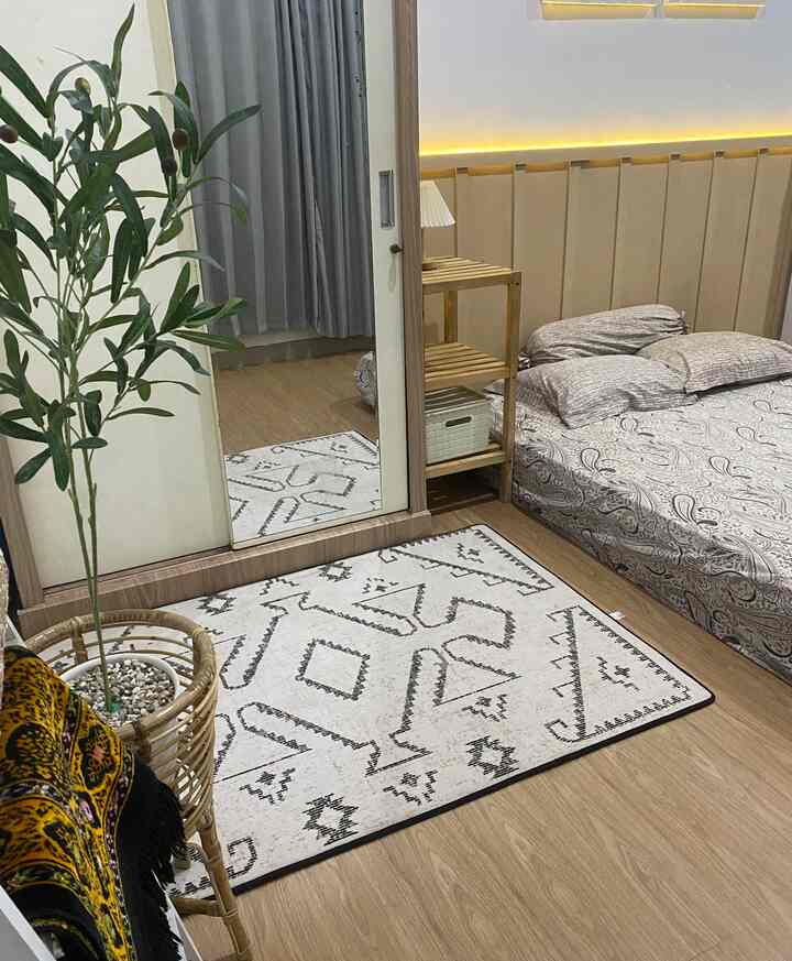 Natural wood tone bedroom with beige hues, compact space featuring bed and wooden shelf creating a harmonious atmosphere