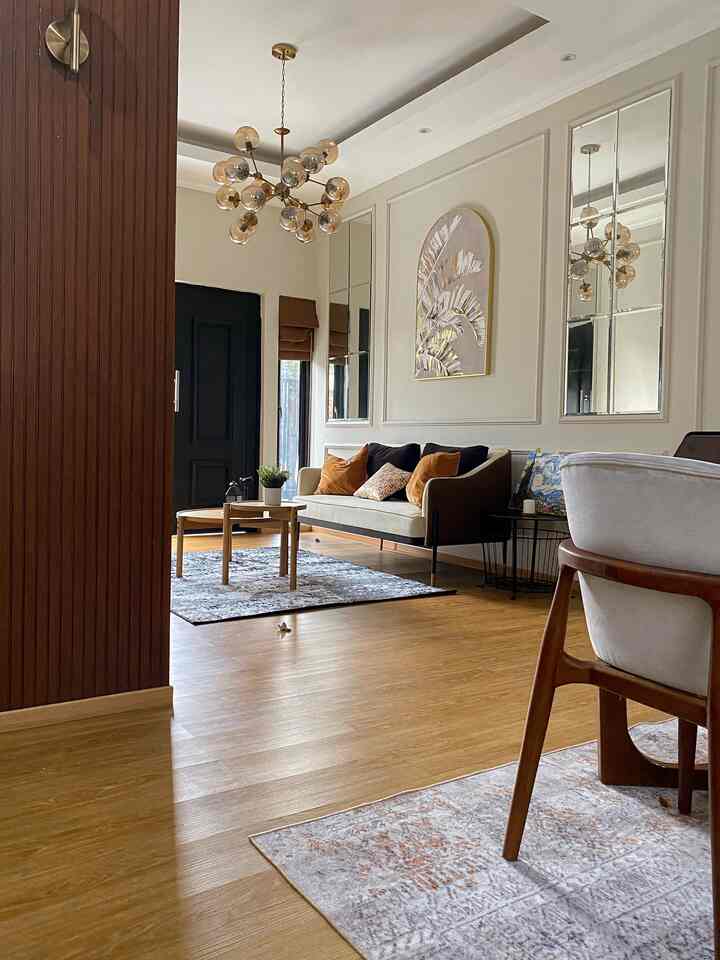 Brown and ivory toned living and dining rooms featuring a sofa, wooden coffee table, and classic warm ambiance
