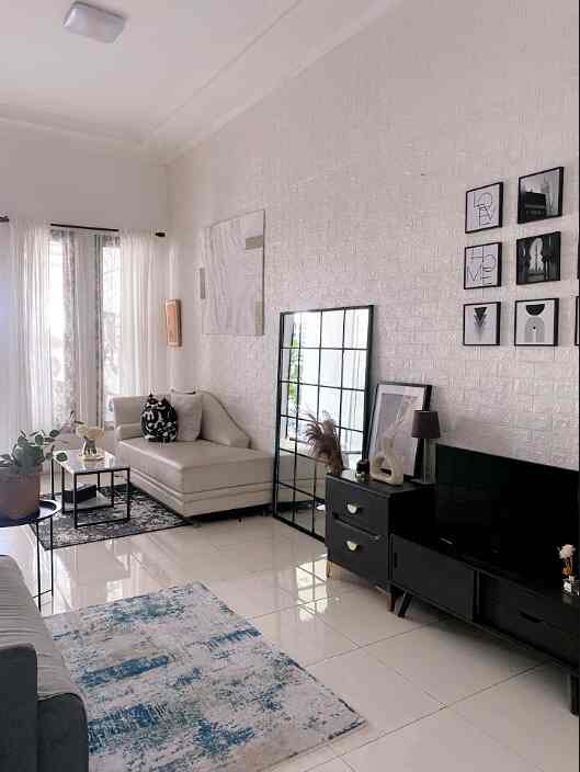Monotone white and black living room featuring a minimalist sofa and TV stand with a clean atmosphere