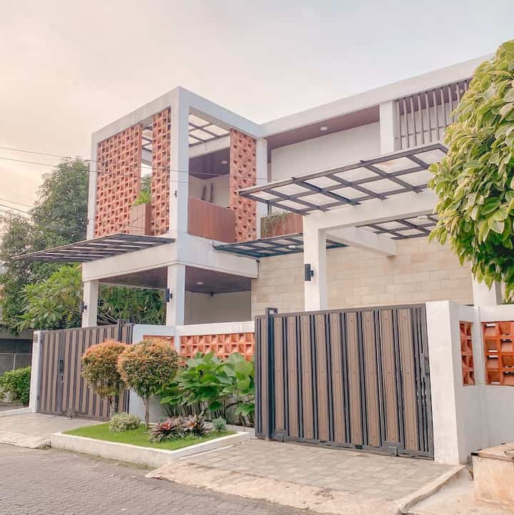 Welcome back to our front house!! 

Kami memilih untuk menggunakan roster pada bagian fasad kami, karena kami ingin menciptakan kesan suasana yang sejuk dan alami.

Agar lebih alami kami juga memakai batu andesit sebagai lantai garasi juga paras yogya pada dinding rumah bagian luar.

Walau kami hanya memiliki sedikit lahan untuk taman, tapi tetap merawat beberapa tanaman agar rumah semakin adem. 

Kedepannya, kami ingin menumbuhkan tanaman menjuntai dari atas seperti lee kwan yew. Sebenernya sudah beberapa kali dicoba namun tidak ada yang berhasil.. 🥲



#InspirasiFasadRumah 
#FacadeIdeas
#GayaFasad