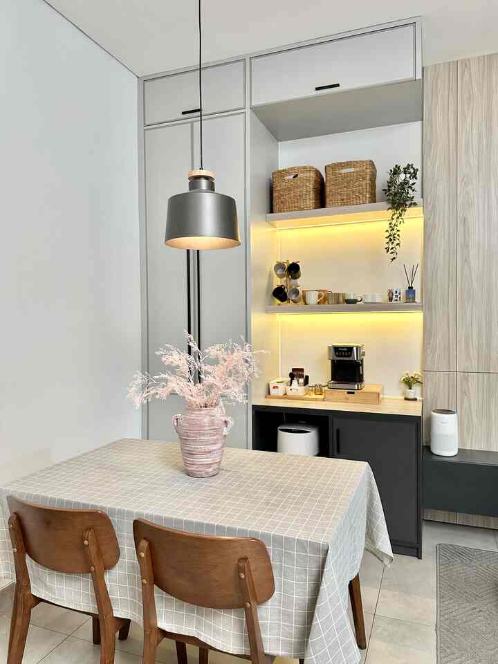 Natural tones and brown hues in a home cafe space featuring wooden chairs and a checkered tablecloth with cozy cafe style interior