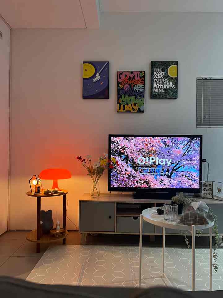 White and brown toned living room with TV stand and posters arranged creating cozy atmosphere