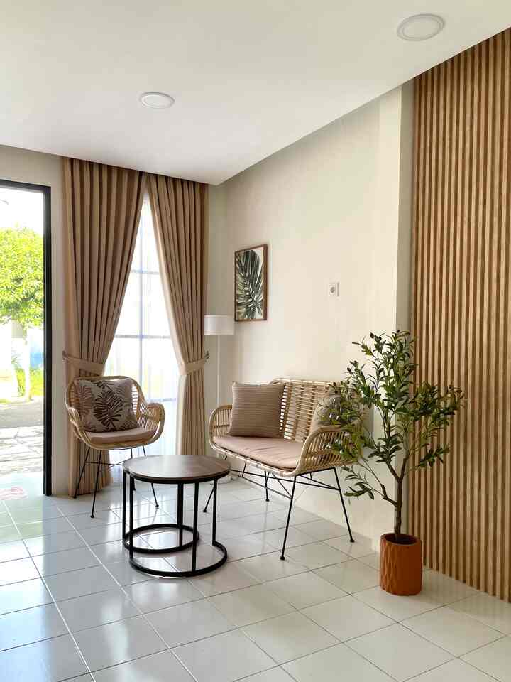 A minimalist living room in beige and wood tones, featuring rattan furniture and a plant for a natural atmosphere