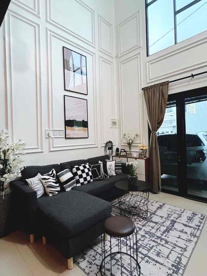 Monotone black and white living room featuring a sectional sofa and abstract carpet in a modern, clean space