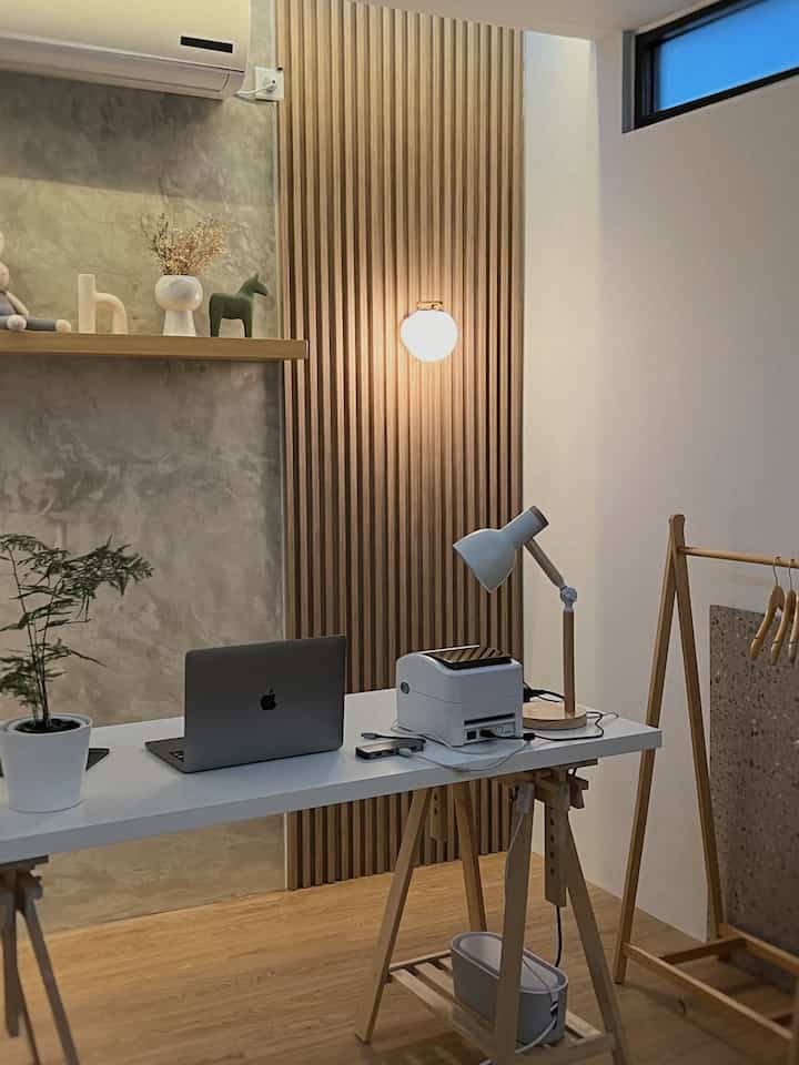 A 3x3m mini home office featuring natural wood tones and white, with a desk holding a laptop and printer in a simple, warm atmosphere