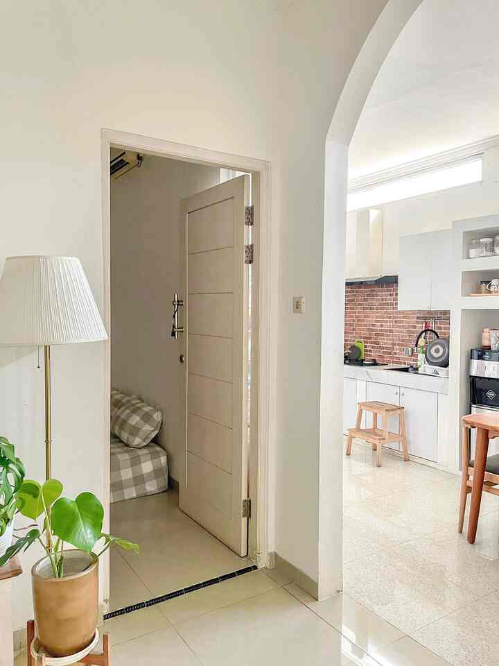 Beige and wood tone kitchen with living room entrance, presenting a natural and calm interior space