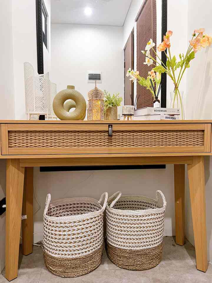 Beige-toned natural modern entrance featuring a wooden console table with rattan baskets and decorative vases creating a cozy atmosphere