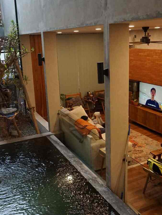 Natural brown and orange toned living room featuring large sofa and carpet with cozy atmosphere