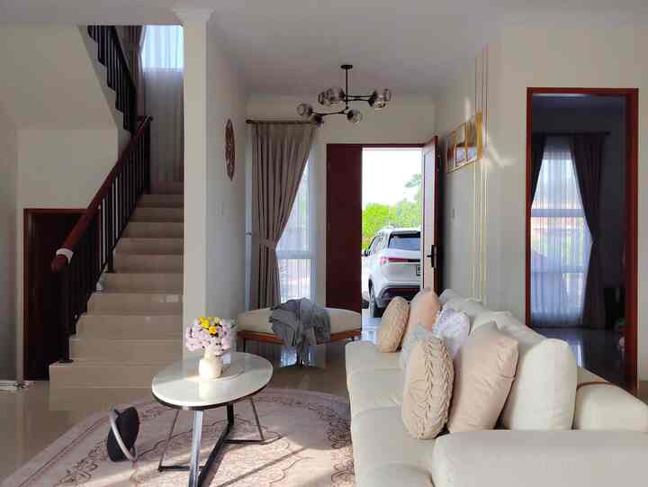 White and brown toned living room featuring sofa and coffee table with natural, bright atmosphere