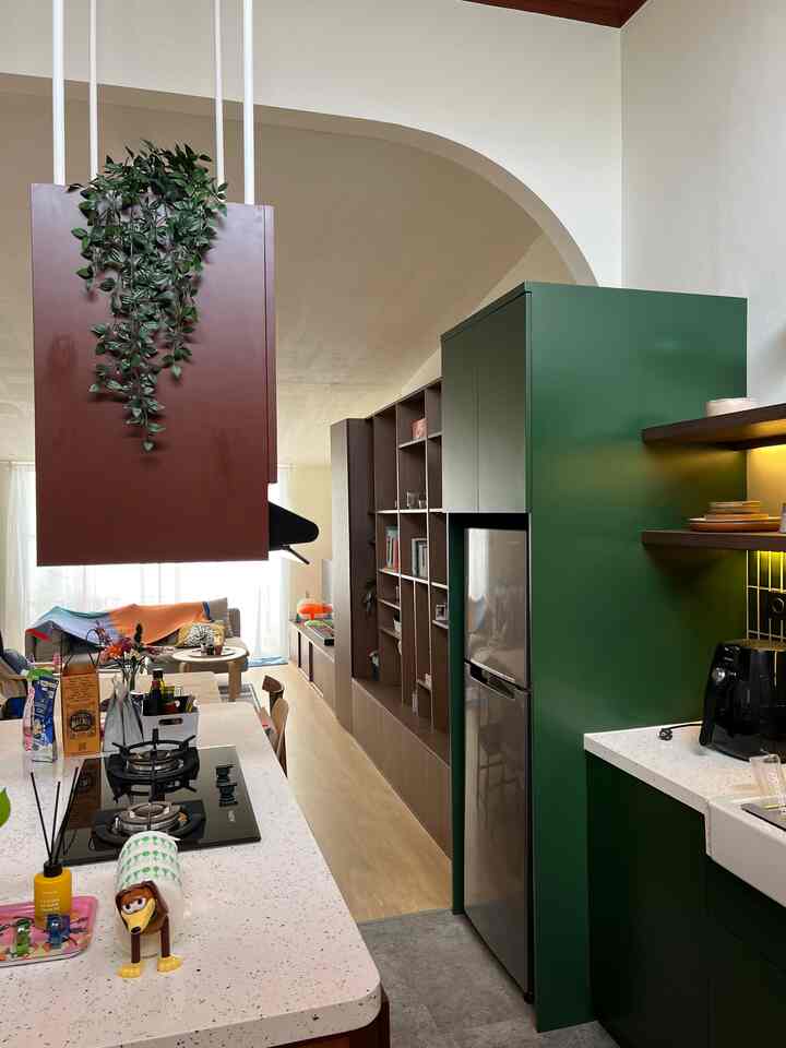 Natural color tones and wood accents in a compact, cozy apartment kitchen and living room interior