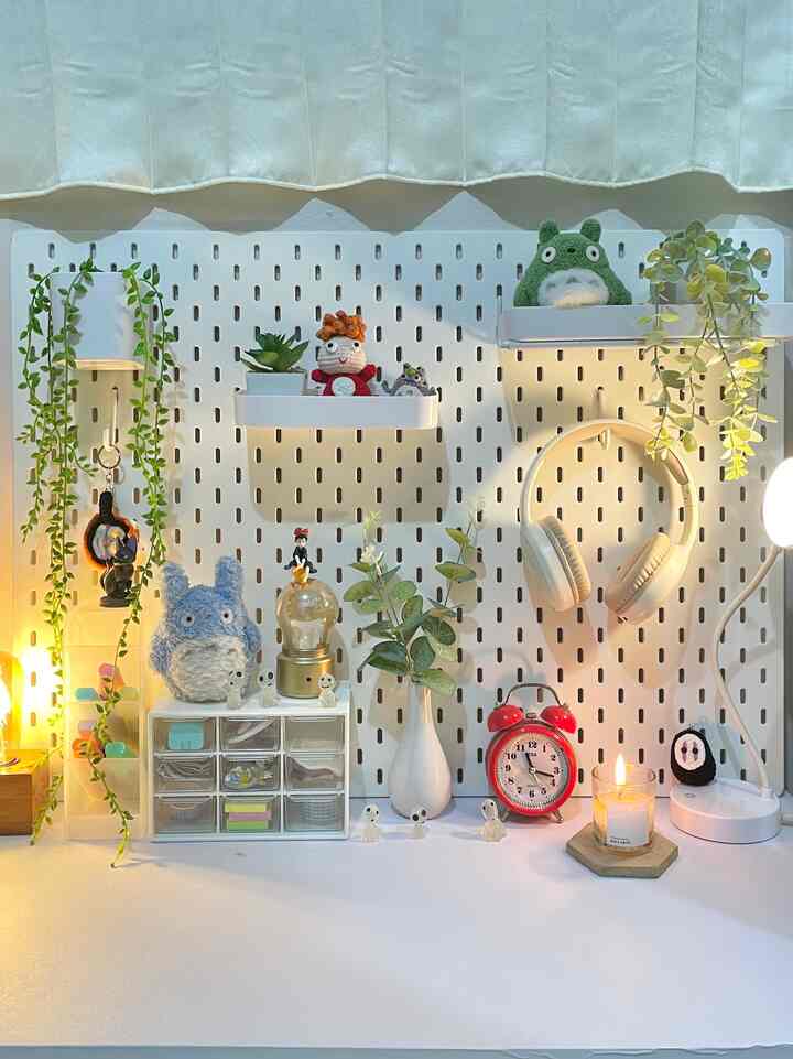 White and natural toned study space featuring Totoro plushies, plants, headphones and cute decor items with cozy atmosphere