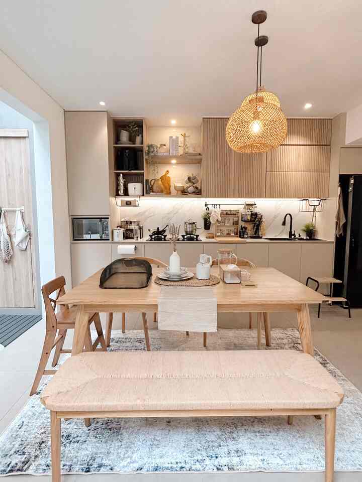 Bright wood tones and white kitchen and dining space featuring natural elements with a clean, cozy atmosphere