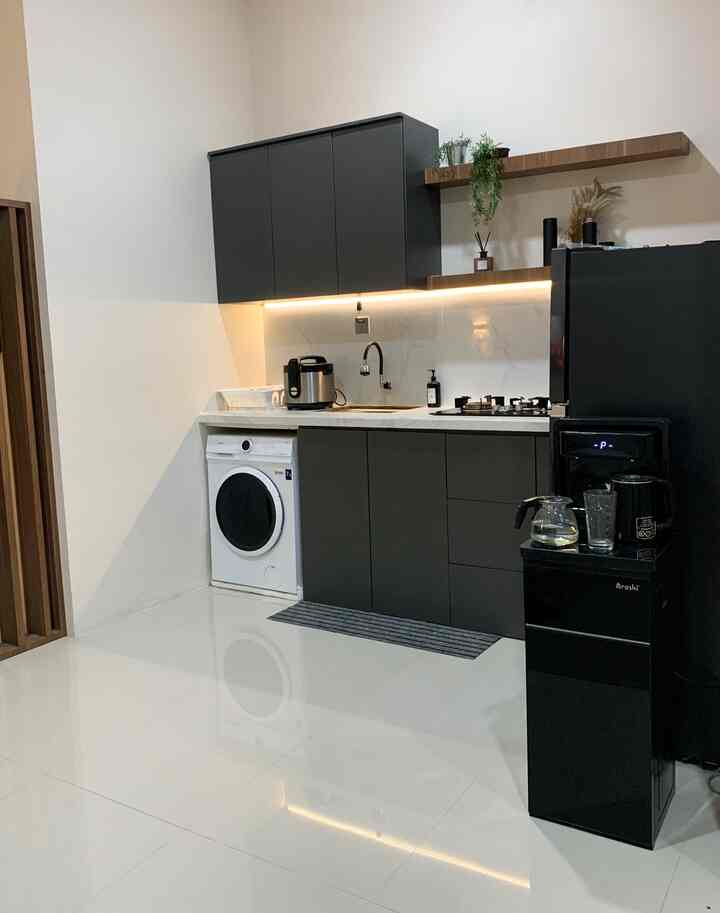 Modern kitchen with black matte cabinets, white tiled floor, and wooden shelves arranged neatly