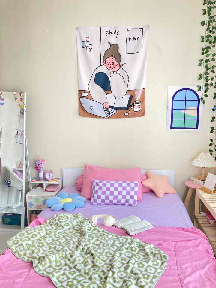 Pastel-toned bedroom featuring a pastel purple bed with various cushions and charming wall decor above, creating a cozy atmosphere