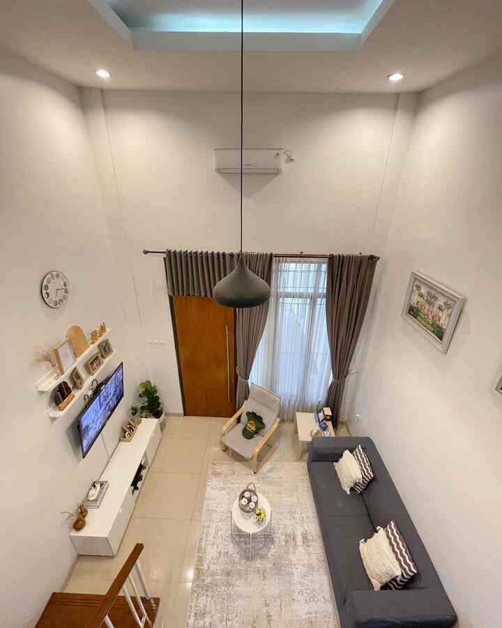 White and gray toned living room featuring a gray sofa, armchair, and pendant light with a clean modern atmosphere