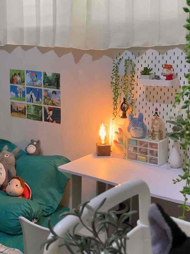 White and green toned single household room featuring a desk and sofa bed with warm lighting creating a cozy atmosphere