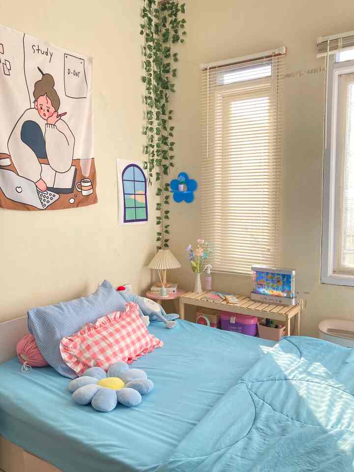 Sky blue bedroom featuring pillows and blinds with a cozy and bright atmosphere