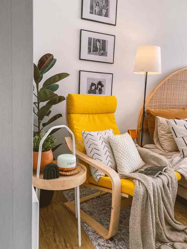 Natural tone living room with bright white walls, yellow armchair and floor lamp