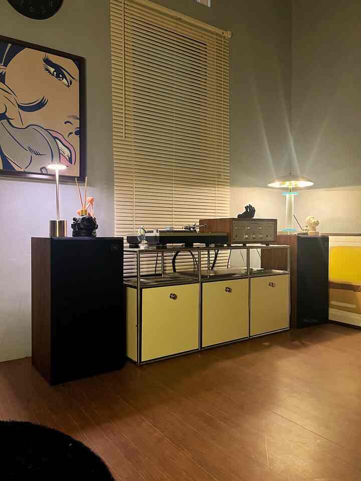 Wood tone flooring with vintage retro audio equipment arranged in a cozy space