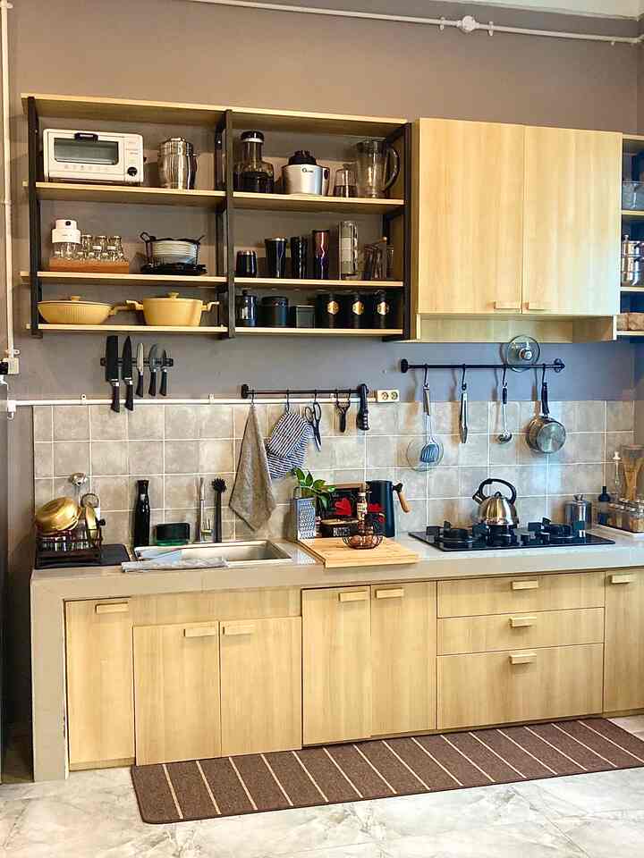 Wood tone and gray kitchen featuring cutting board and pot, creating a practical cooking space