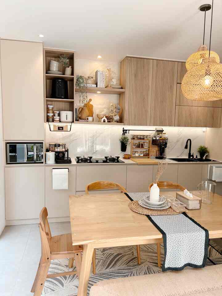 Natural-toned kitchen and dining room featuring a wooden dining table and rattan pendant lights with a warm cozy atmosphere