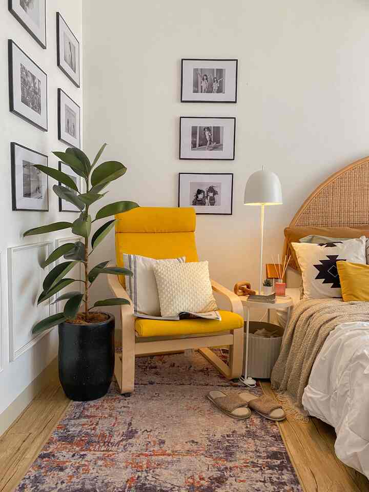 Natural beige and wood-toned bedroom featuring a yellow armchair and floor lamp creating a cozy atmosphere