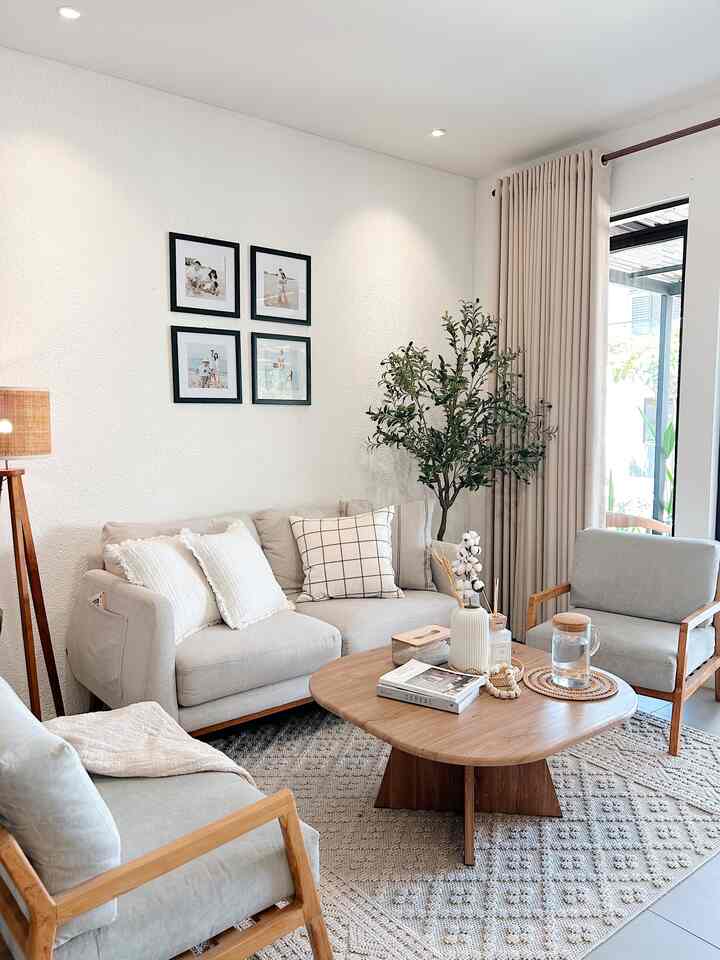 Soft gray and wood tone furniture arranged in a natural living room space featuring bright and simple atmosphere
