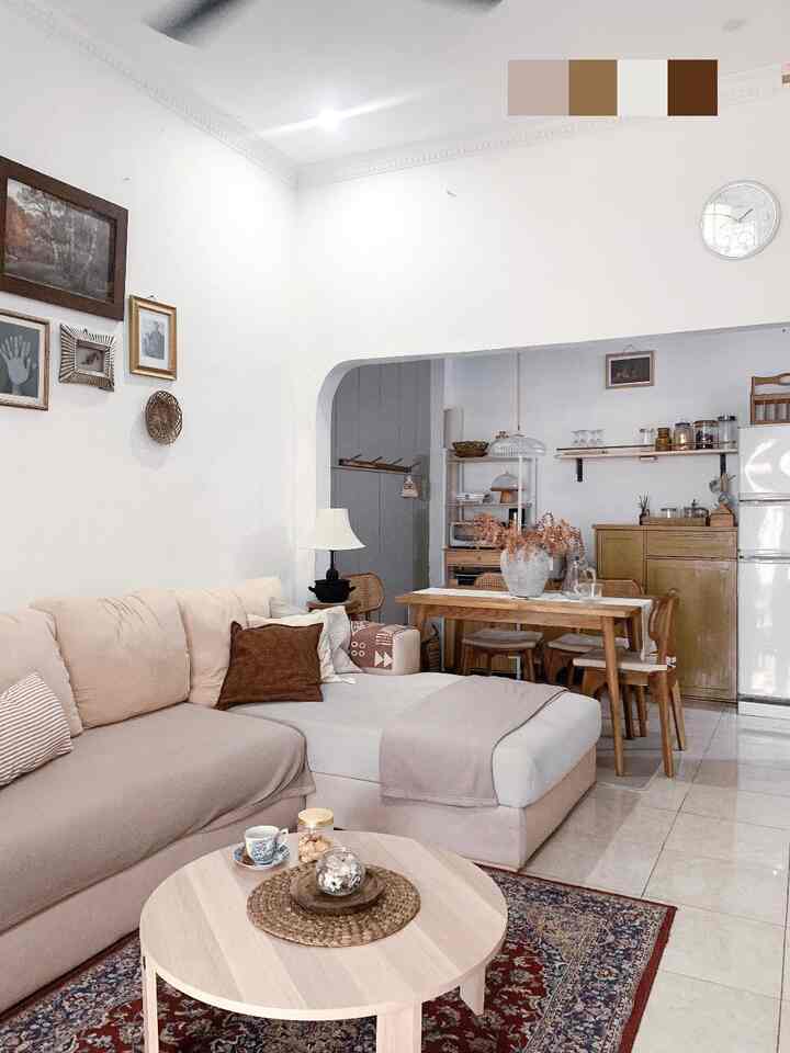 Cozy living room and dining area with white walls and wood tone furniture in natural style