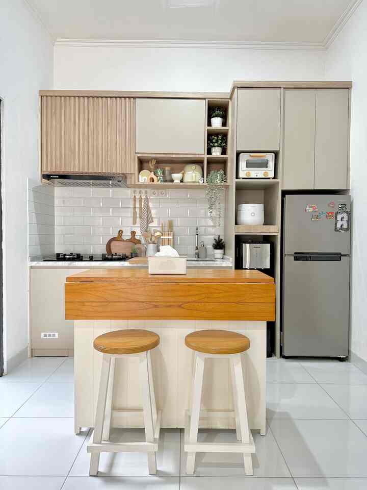 Bright white and beige kitchen with wood-toned kitchen island and stools in a compact, minimalistic space