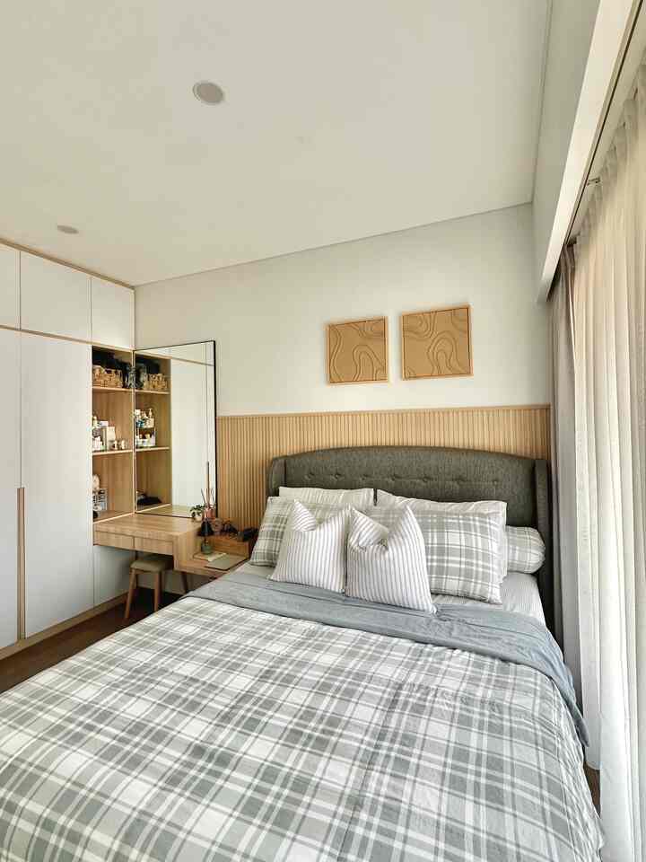Natural and gray tone bedroom featuring a neat bed and storage cabinets in a modern, compact space