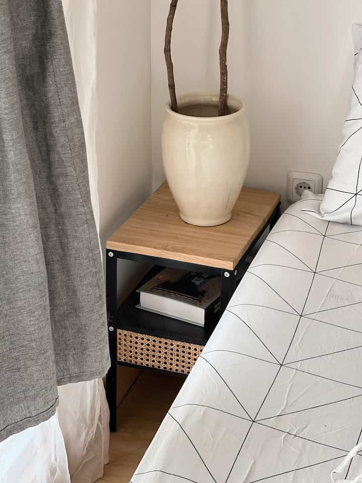 Corners with Narrow Area.

The size of our main bedroom was a bit strange. So, the placement of the cot is also our consideration so that other space can still be utilized. So, this is the angle that we are actually a little confused about, what to do with it? Because the area is only 40x30. Even if you want to install a nightstand, at least it's custom (it takes up quite a big budget too).

As a result, we found an Ikea nightstand that was Knarrevik because it was the right size. However, the style of the house doesn't match (even though the color is black). Finally, we DIYed it by adding rattan and we covered the table base with wood to fit the Japanese theme.

What do the O House neighbors think? Isn't the result beautiful?

#Small Space #Ruangterbatas #NeverTooSmall #JapandiNakas #Japandiinspired #japandi #japandidesign