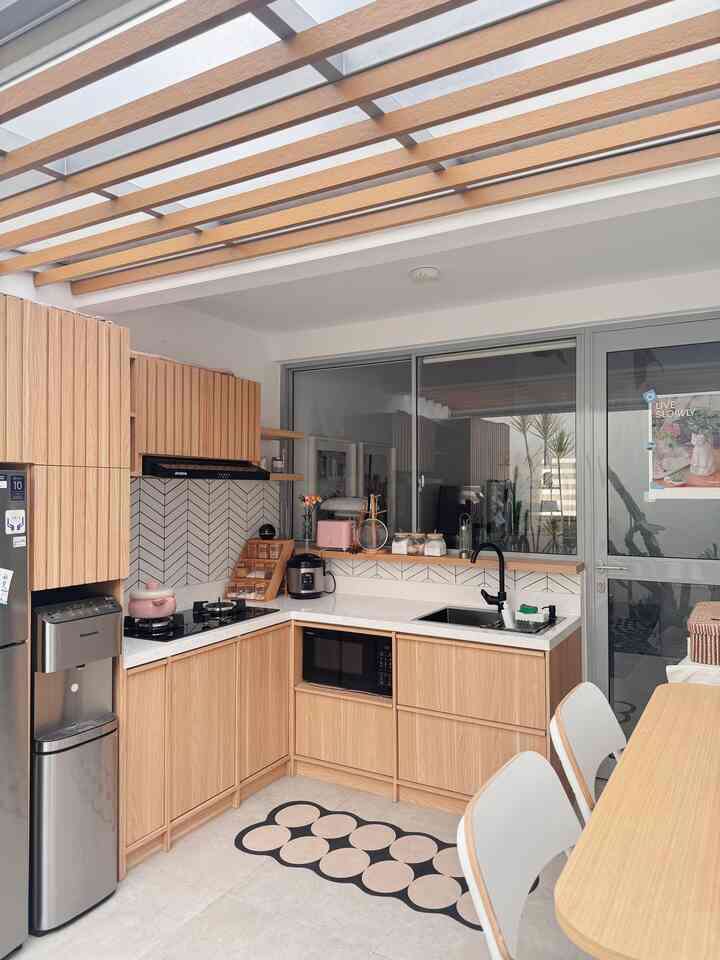 Clean kitchen space blending natural wood tones and white colors, featuring modern storage ideas and stainless steel appliances