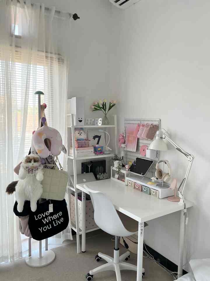 Bright white and natural tone home office space featuring a tidy desk and shelving with functional elements